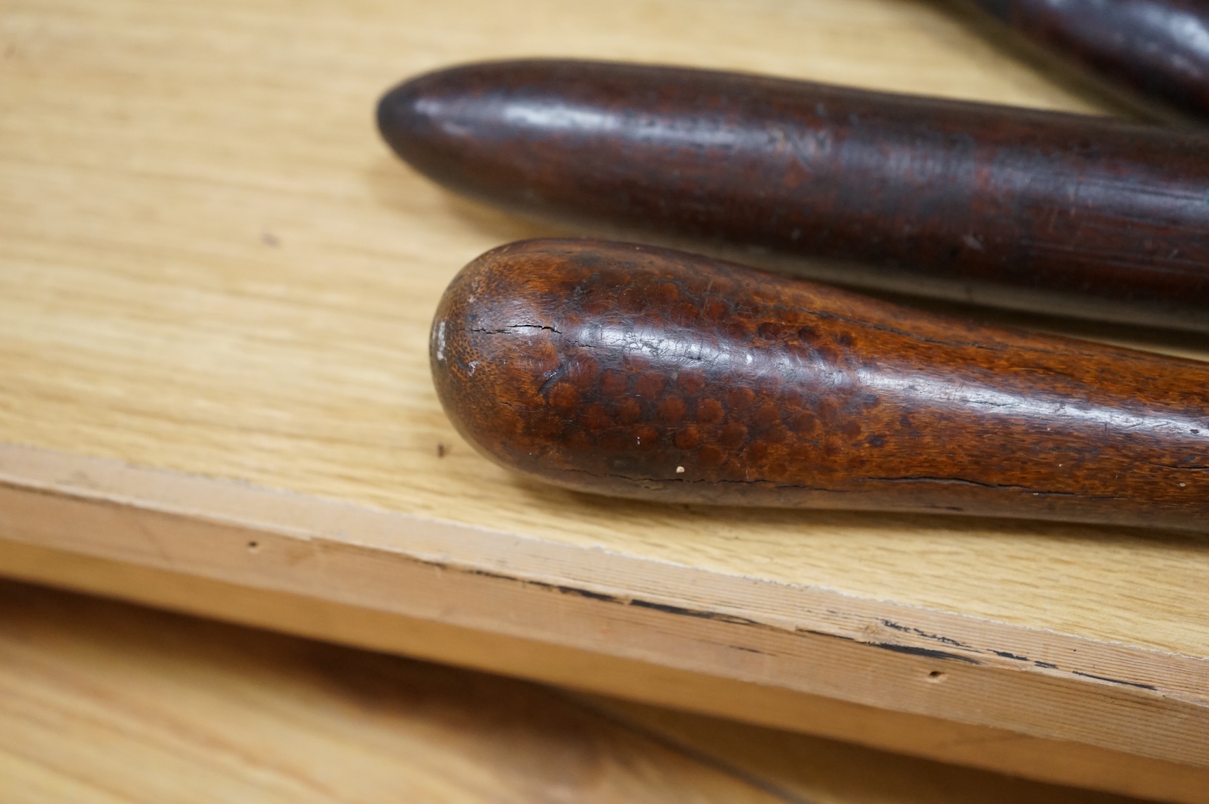 A Fiji hardwood club, probably 19th century or earlier, of gunstock form, overall length 89cm, together with a pole club, probably from Samoa, and a wooden walking stick (3)